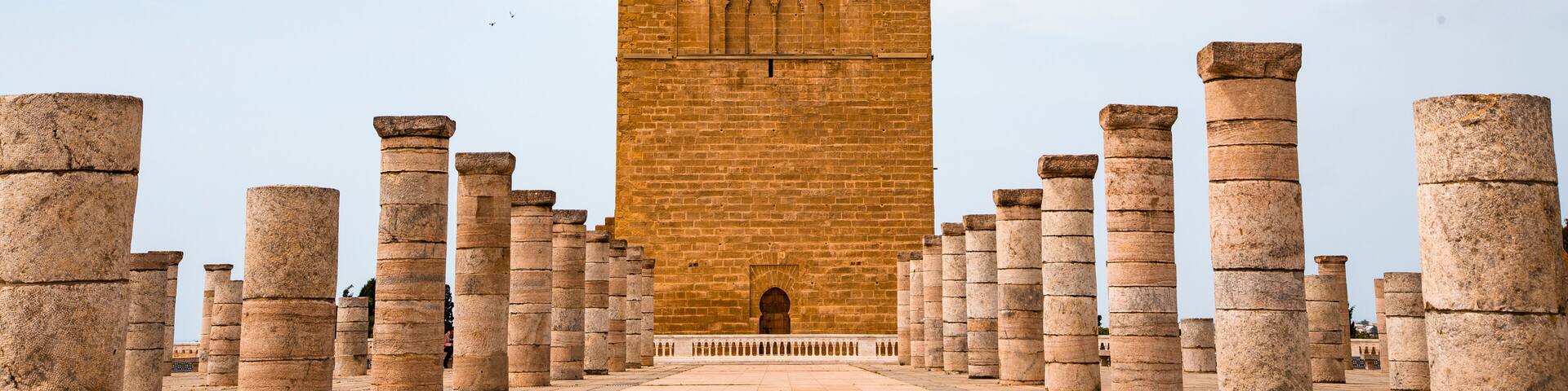 Tour Hassan tower in the square with stone columns. Made of red sandstone, important historical and tourist complex in Rabat, Morocco