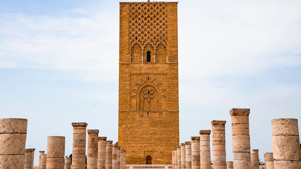 A tall, ornate tower with intricate carvings and columns at its base.