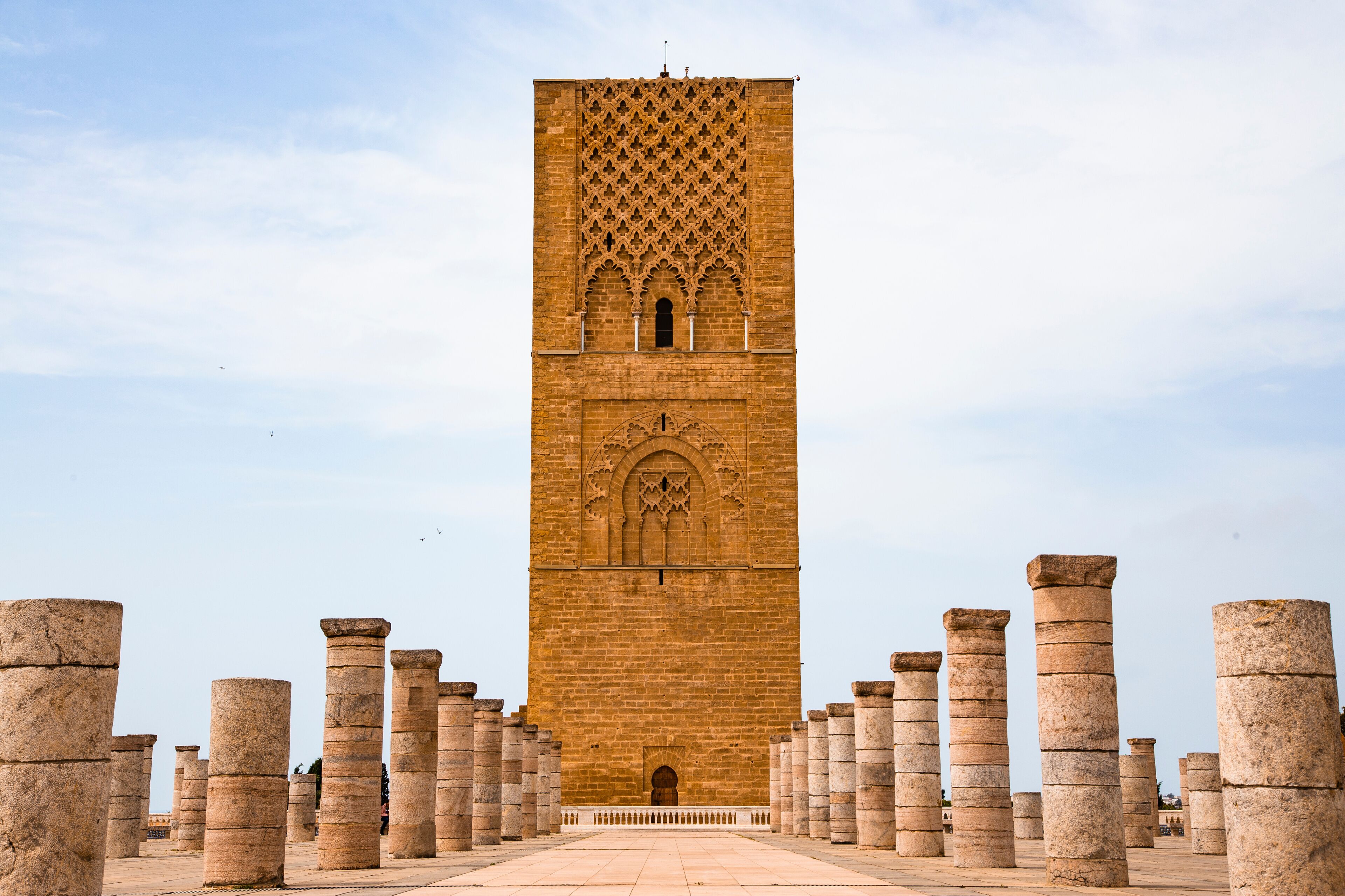 A tall, ornate tower with intricate carvings and columns at its base.
