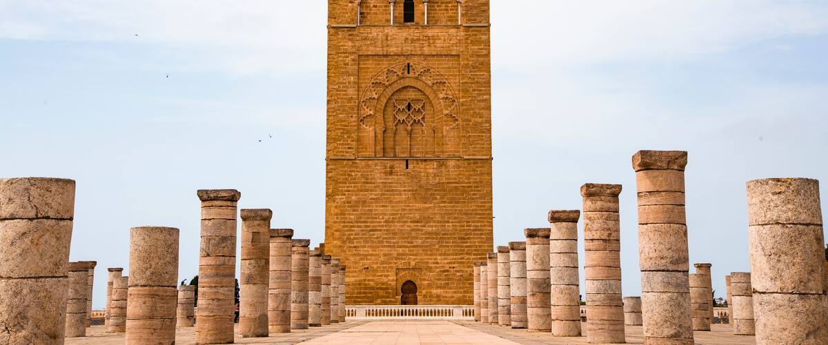 A tall, ornate tower with intricate carvings and columns at its base.
