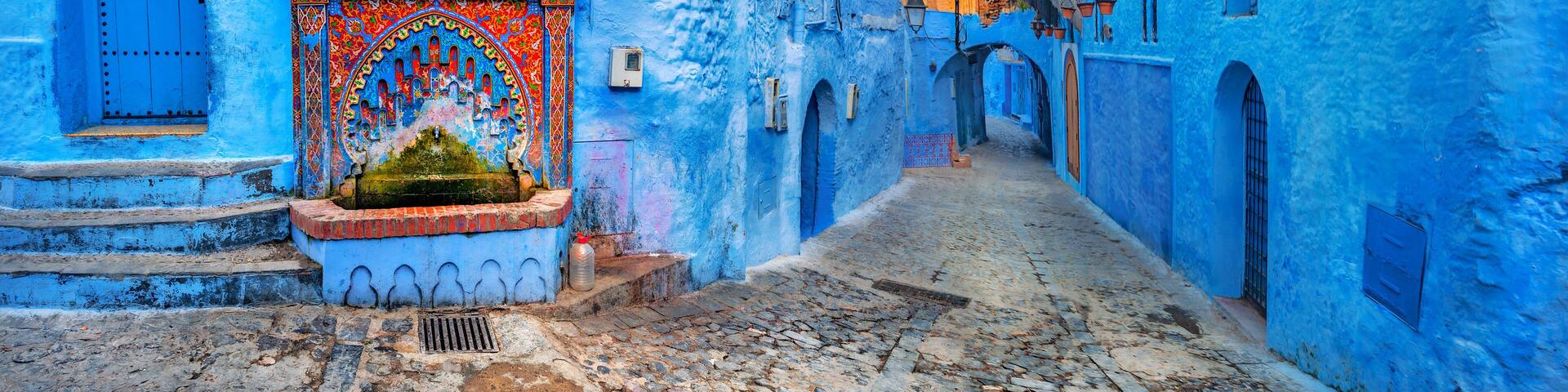 Fountain with drinking water on house coloured wall in blue town Chefchaouen. Morocco, North Africa