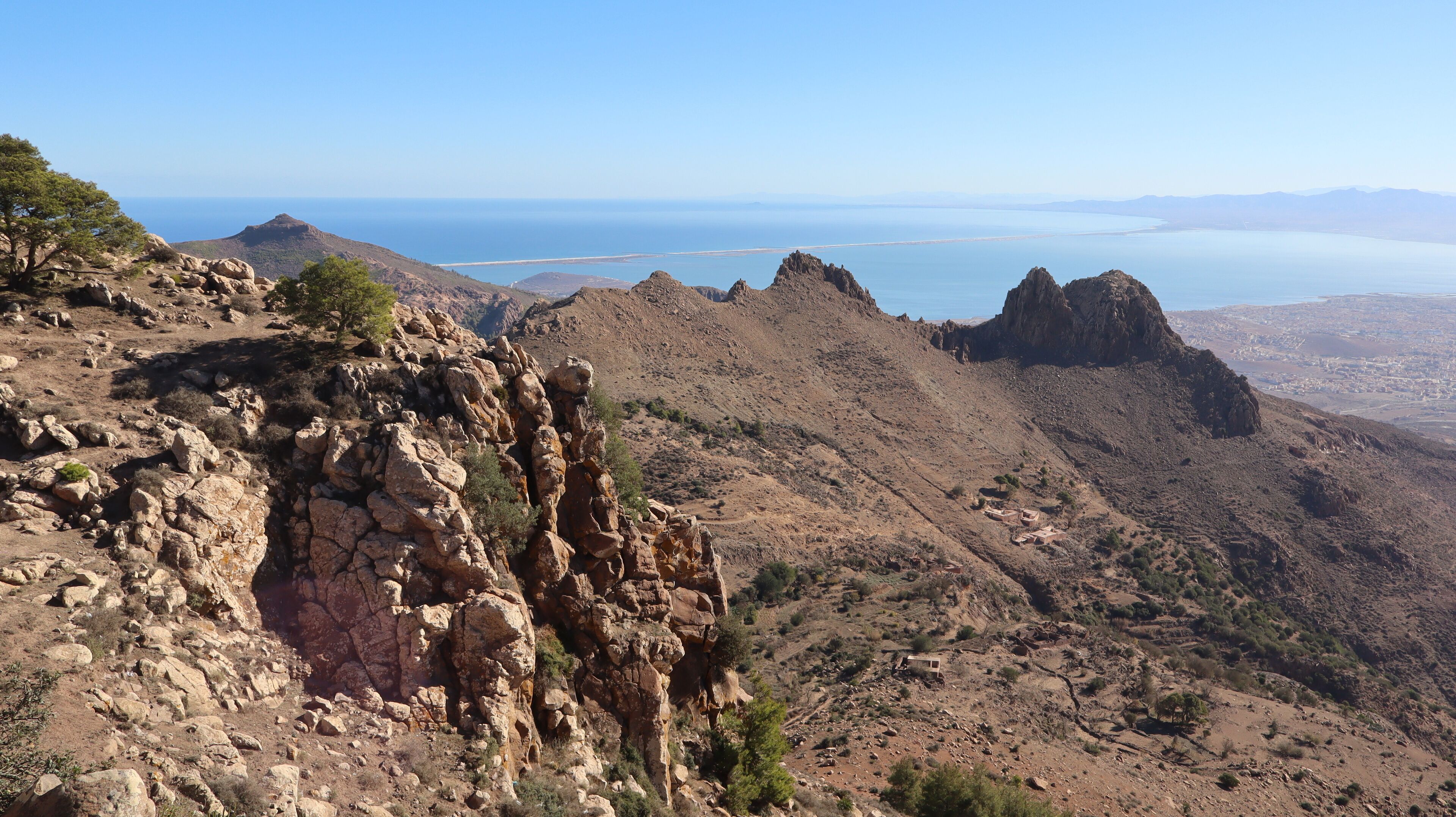 A rugged mountain landscape with rocky outcrops and sparse vegetation.