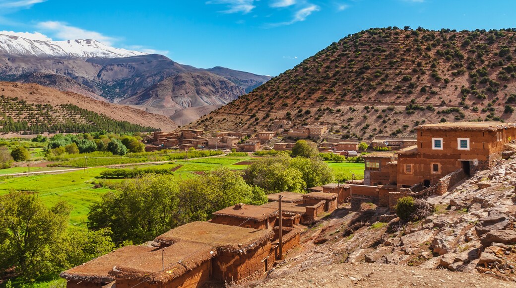 View of adobe house village in the high snow-capped mountains in the Aït Bouguemez valley in Morocco