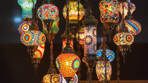 A collection of colorful, mosaic-patterned hanging lamps.