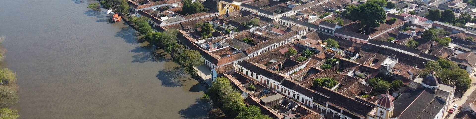 Aerial view of the historic city of Santa Cruz de Mompox in sunlight with the river and the Iglesia de Santa Bárbara (Church of San Bárbara) Colombia, a World Heritage Site
