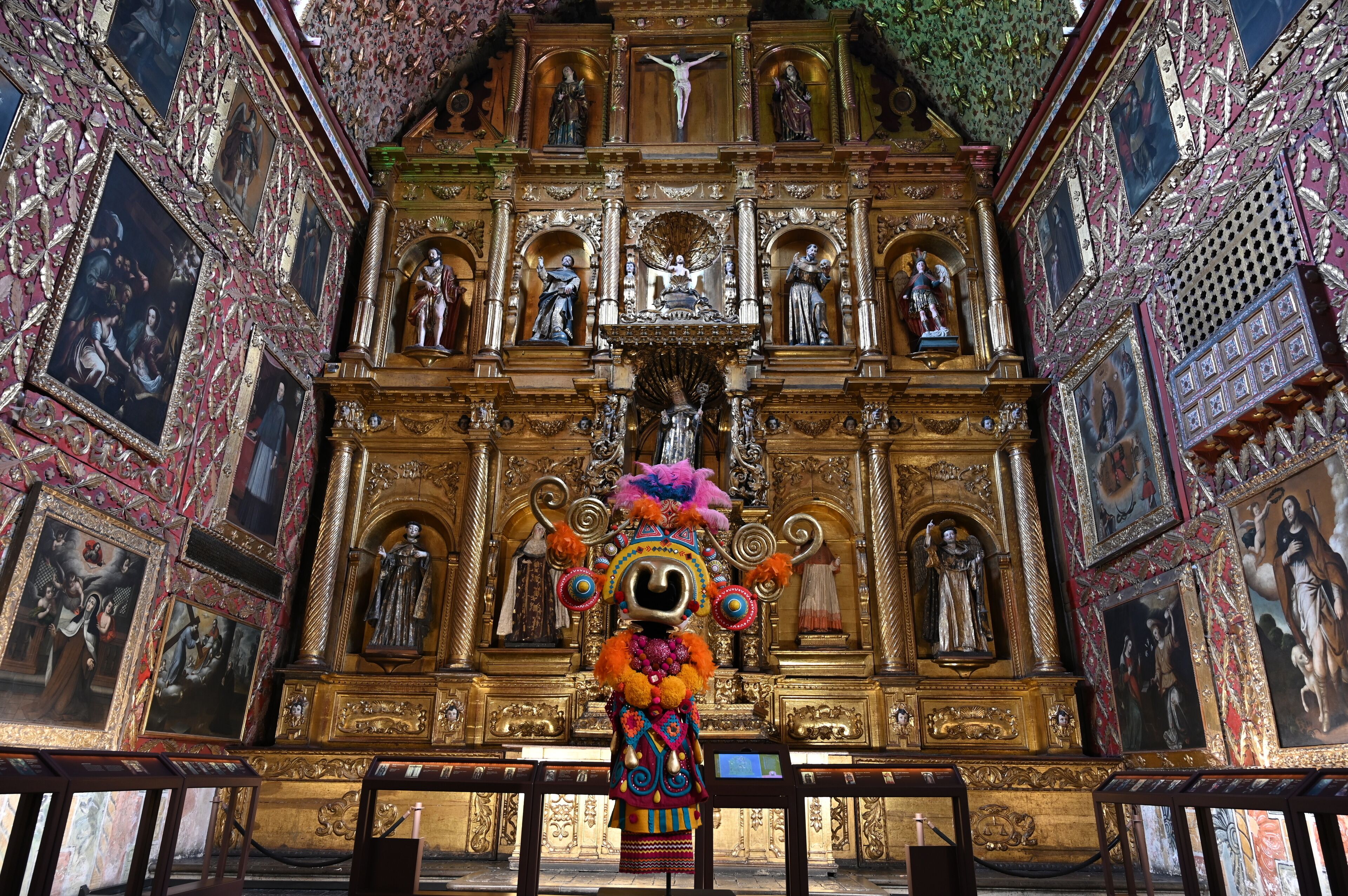 A richly decorated altar with religious statues and paintings.