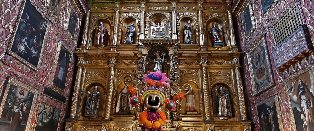 A richly decorated altar with religious statues and paintings.