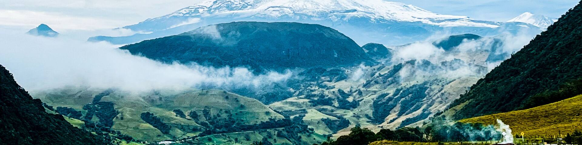 An impressive Nevado del Ruiz Volcano: Natural Beauty Near Manizales half covered with white heavy clouds. An active volcano in Murillo, Tolima, Colombia