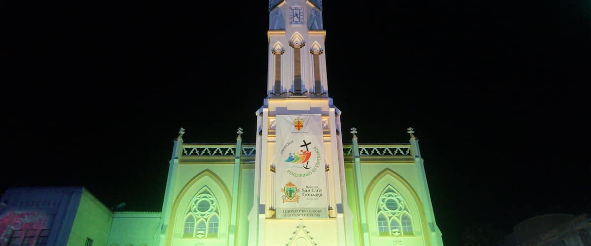A church with a tall spire and a clock.