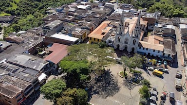 An aerial view of a town with a prominent church, a central plaza, and surrounding buildings.