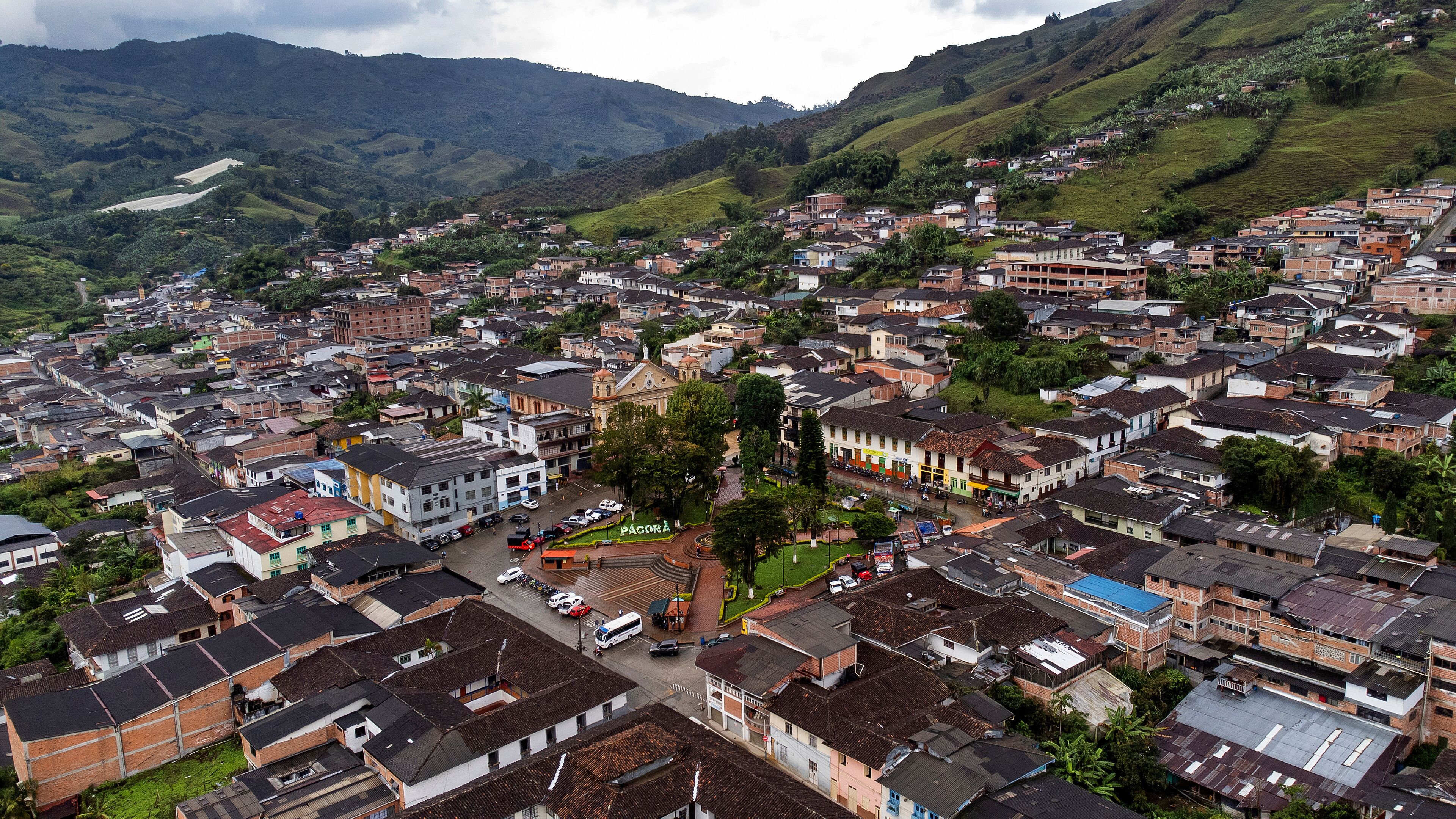 A densely packed hillside town with a prominent church and a mix of residential buildings.