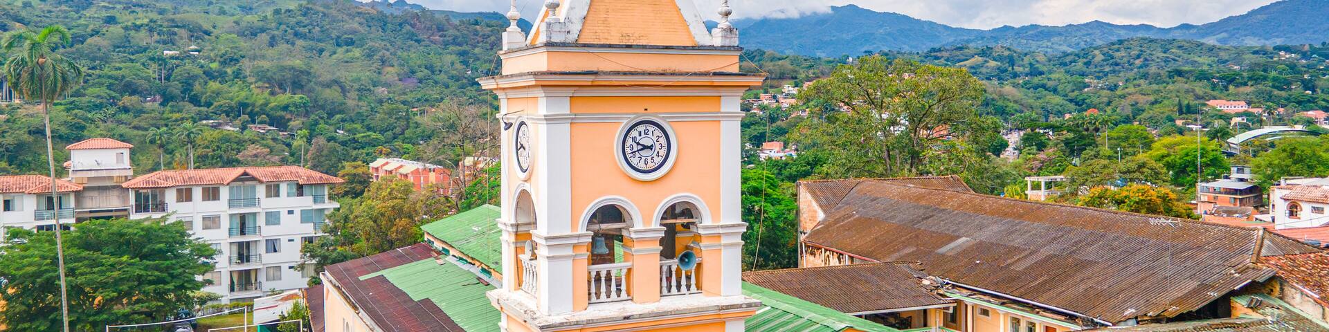 Historic Clock Tower in Villeta, Cundinamarca, Colombia Surrounded by Lush Green Mountains