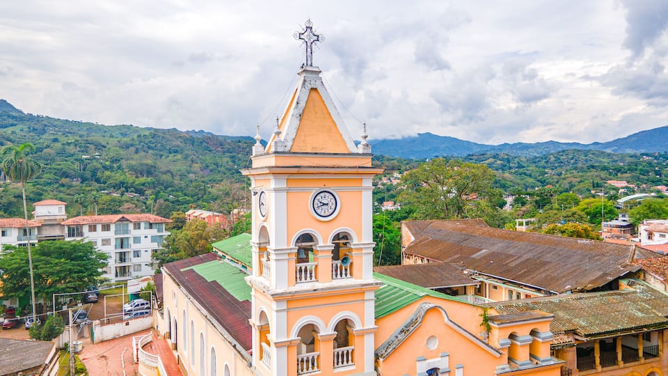 Historic Clock Tower in Villeta, Cundinamarca, Colombia Surrounded by Lush Green Mountains