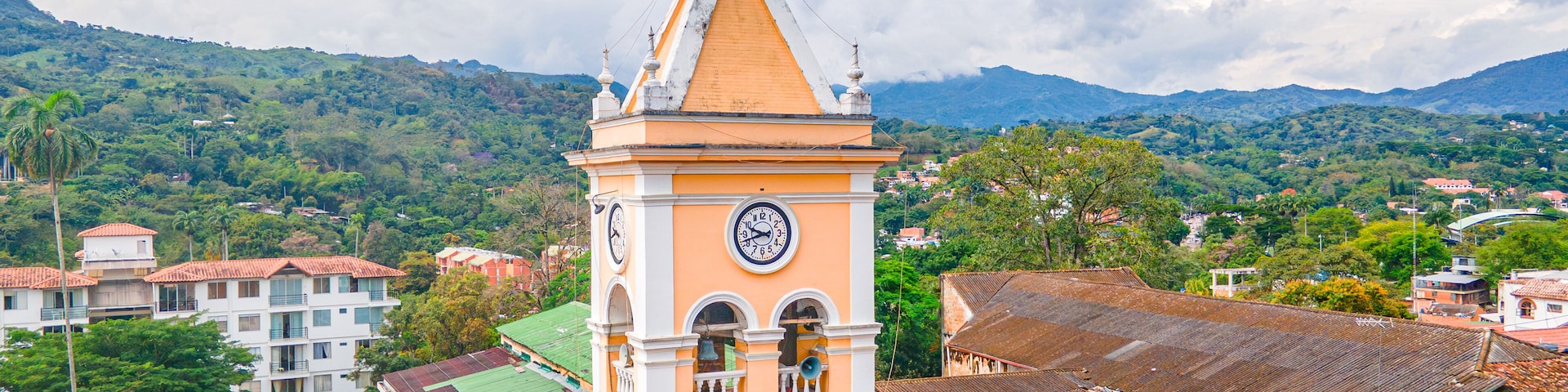 Historic Clock Tower in Villeta, Cundinamarca, Colombia Surrounded by Lush Green Mountains