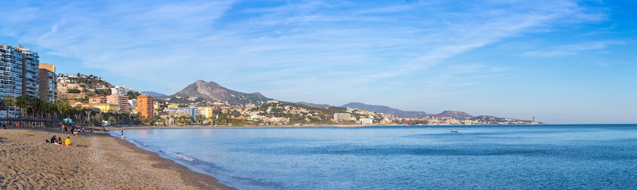 Breathtaking romantic summer panoramic view of Malagueta beach (Playa la Malagueta) in soft evening sunlight. Costa del Sol. Malaga. Andalusia. Spain.