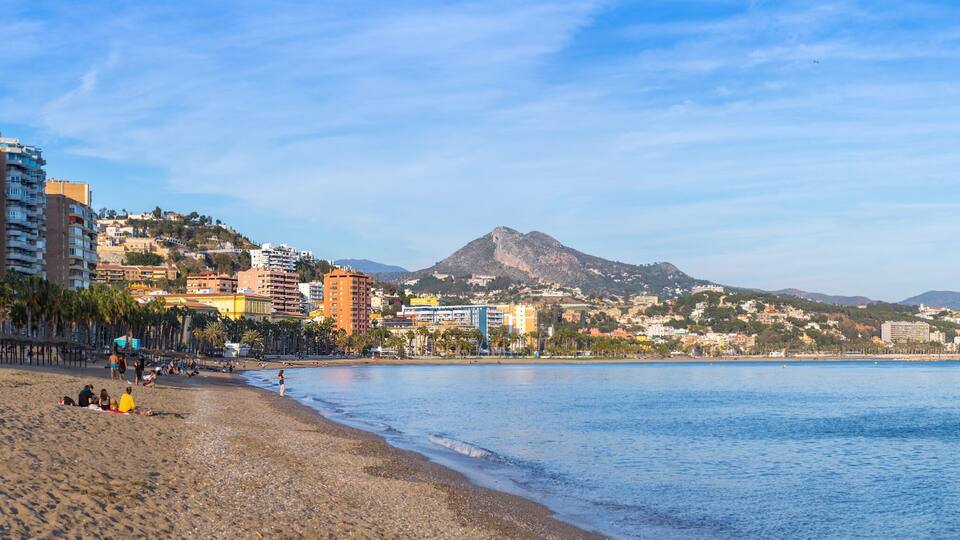 Breathtaking romantic summer panoramic view of Malagueta beach (Playa la Malagueta) in soft evening sunlight. Costa del Sol. Malaga. Andalusia. Spain.