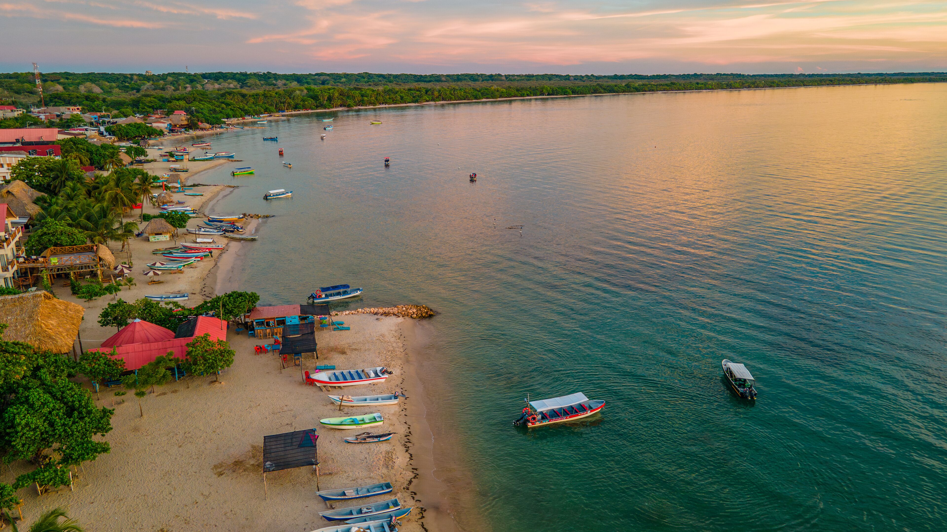 Aerial View of Rincon del Mar Beach at Sunset, Sucre, Colombia, with Colorful Boats and Calm Caribbean Sea