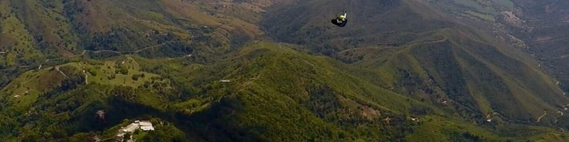 Flying high above Roldenillo, Colombia.
The city is in the distance under the clouds. A great place to visit in central Colombia.