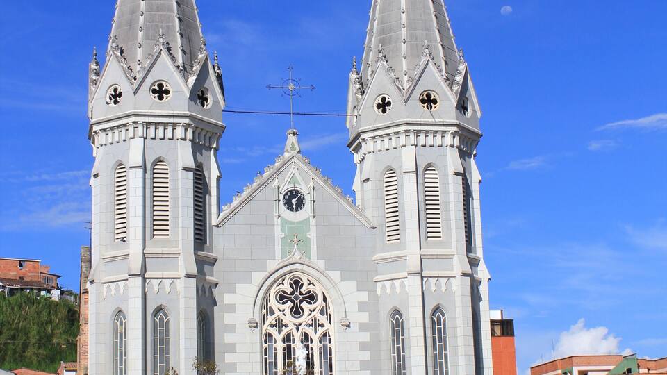A Gothic-style church with two spires and a large rose window.