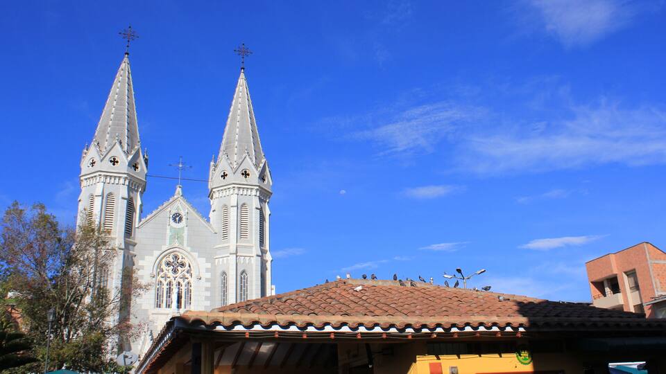 A church with two spires and a tiled roof.