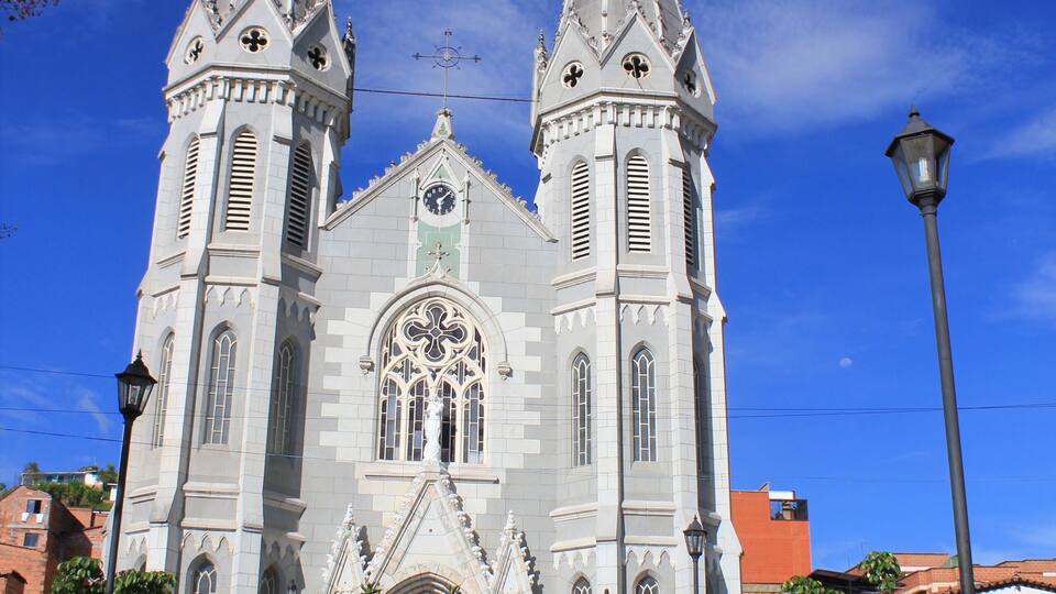 A large white church with two towers and a clock.