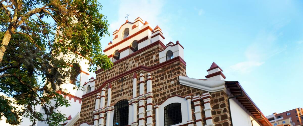 A historic church with a prominent bell tower and arched windows.