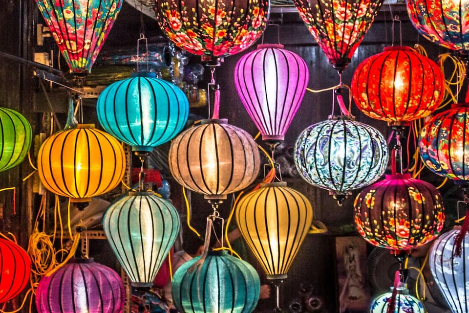 A variety of colorful lanterns hanging in a display.