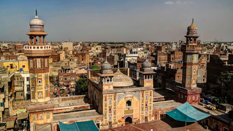 A densely packed urban area with historic buildings featuring domes and intricate tile work.