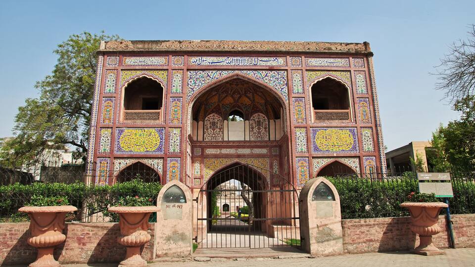 A historic building with intricate tile work and arched doorways.
