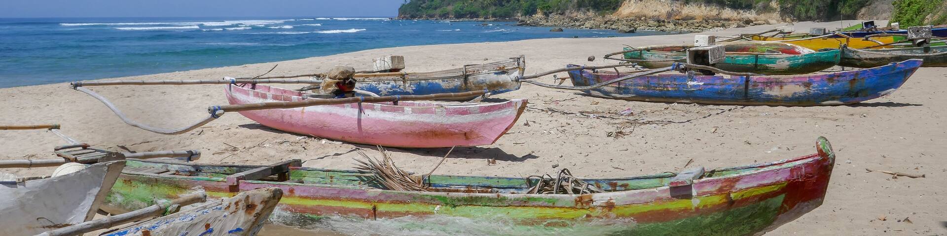 Landscape view of Wanokaka beach with colorful outrigger fishing boats, Lamboya, Sumba island, East Nusa Tenggara, Indonesia