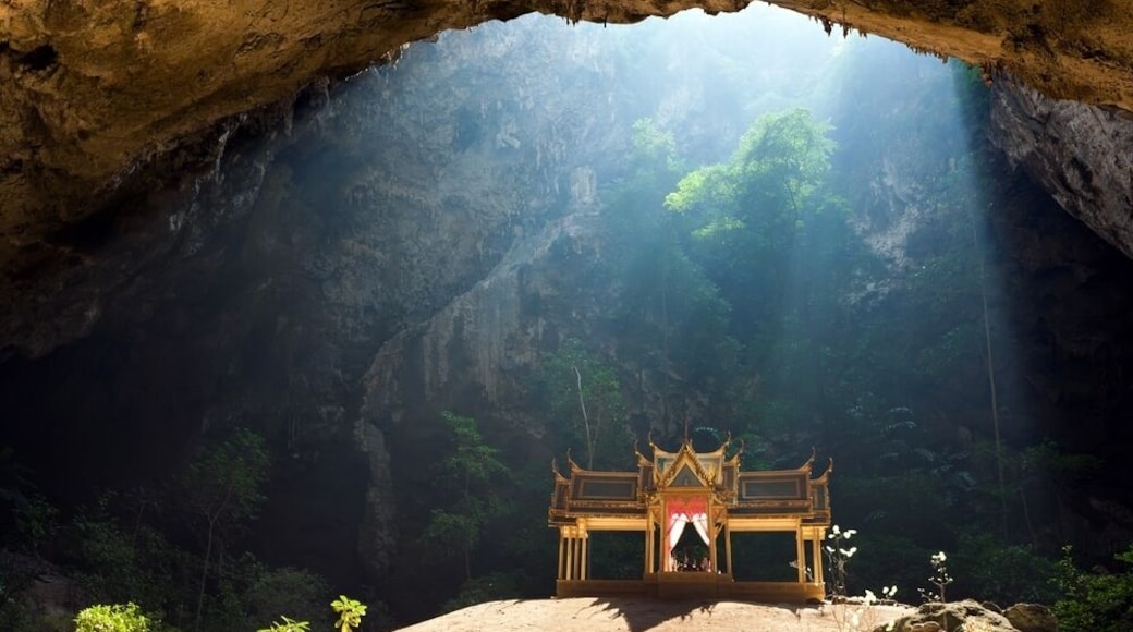 Morning sunbeam on golden buddhist pavilion in wild cave, Sam Roi Yot, Thailand