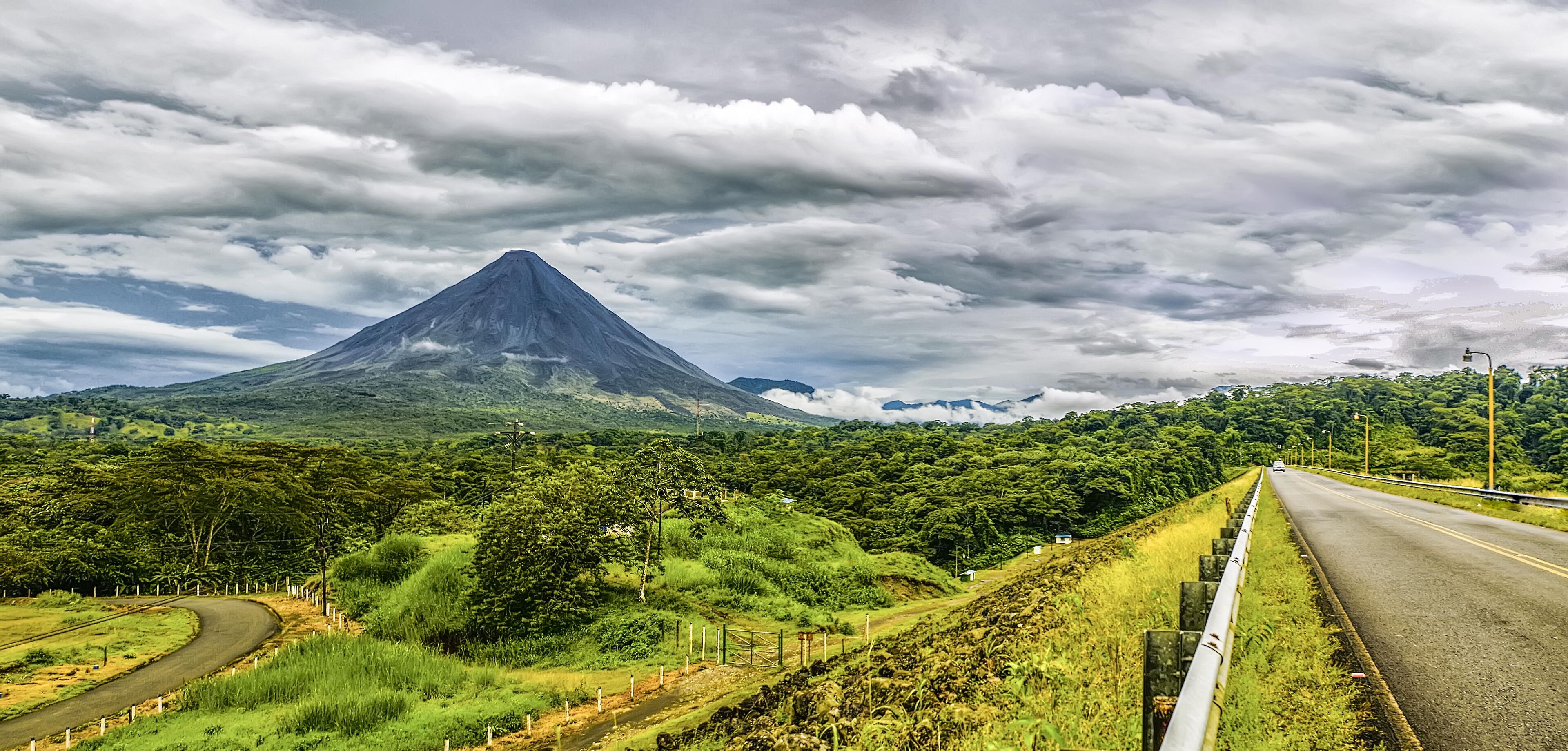 A winding road with a mountain in the background.