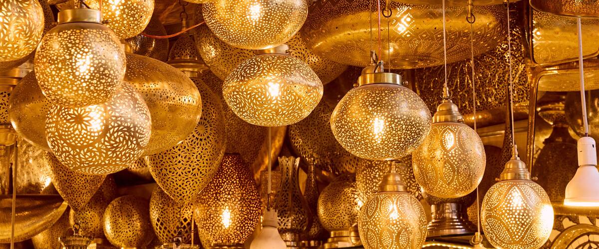 A collection of ornate, golden hanging lamps with intricate patterns.