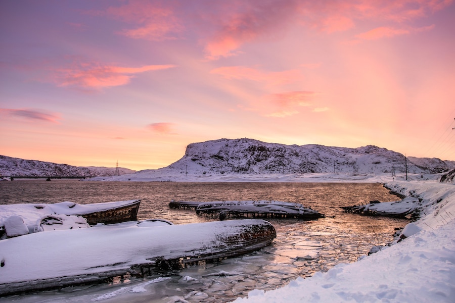 Sunken ships near the snowy coast in Teriberka, Murmansk Region, Russia