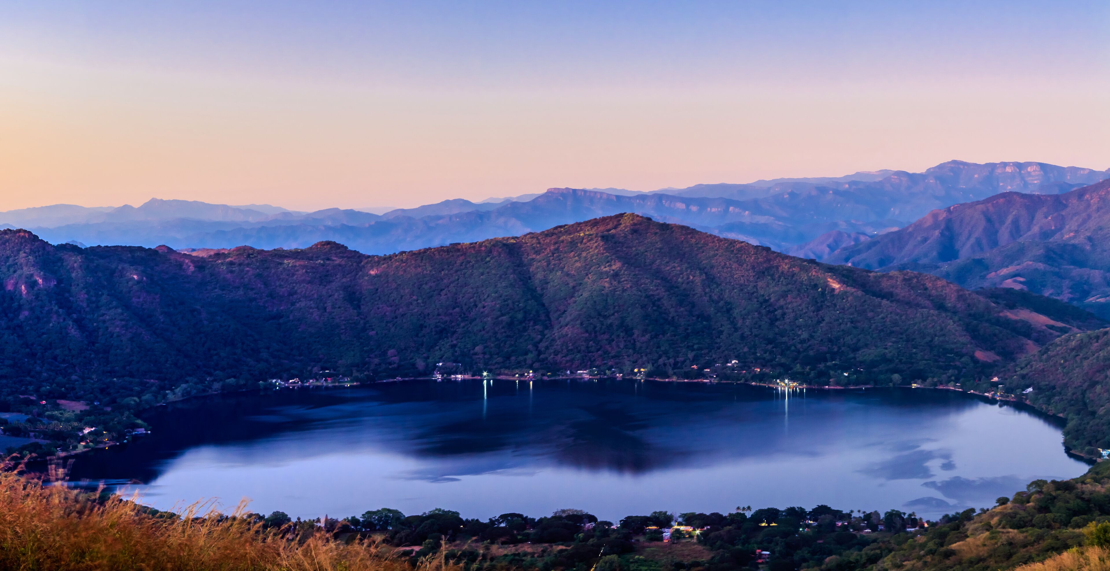 panoramic of bowl with a beautiful lake at sunset with amazing sky in  volcano crater of santa maria del oro nayarit 