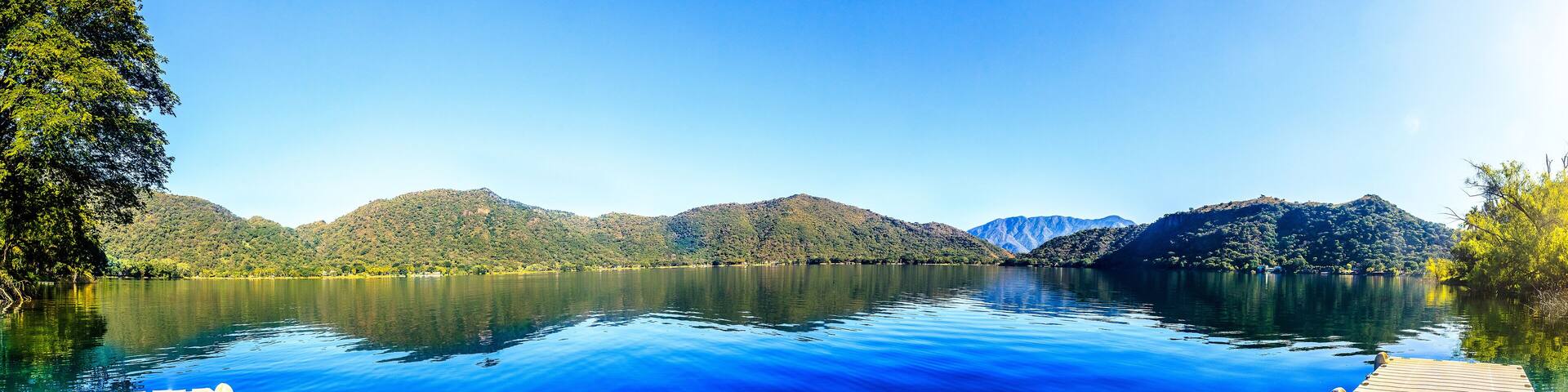180 panoramic of a blue lagoon with mountains in the background and blue sky in santa maria del oro nayarit