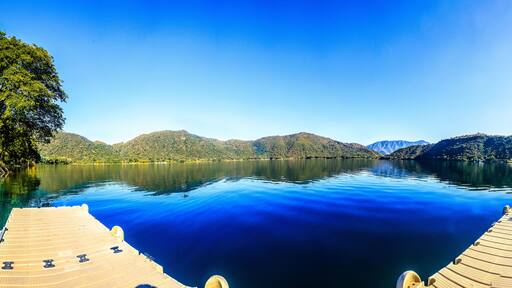 180 panoramic of a blue lagoon with mountains in the background and blue sky in santa maria del oro nayarit