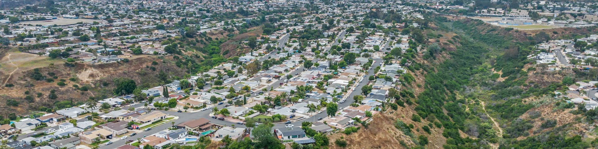 Aerial view of house in Serra Mesa City in San Diego, California, USA. Green Dry Valley and Villas