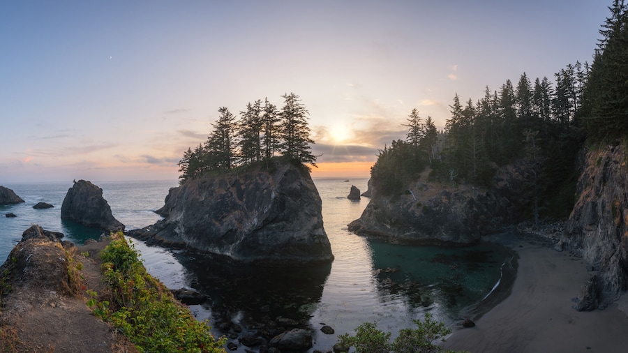 Panorama of Secret Beach in Oregon during a sunset