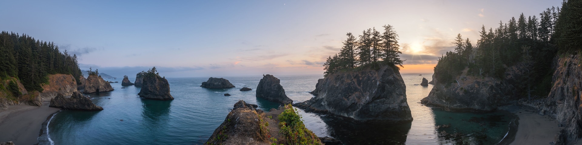 Panorama of Secret Beach in Oregon during a sunset