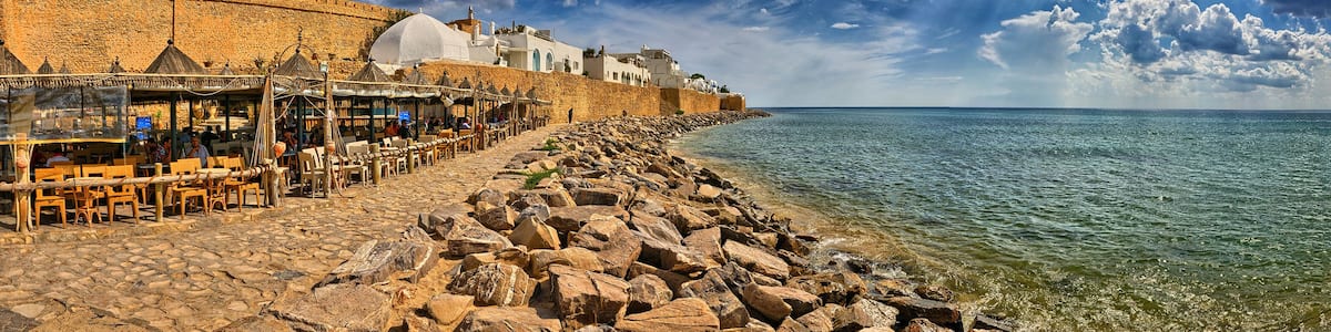 HAMMAMET, TUNISIA - OCT 2014: Cafe on stony beach of ancient Med