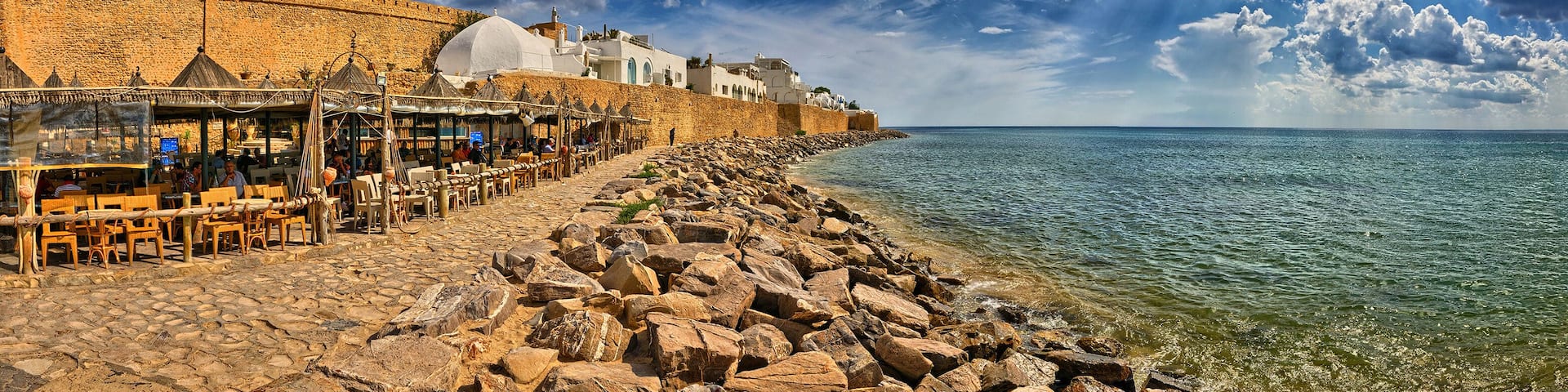 HAMMAMET, TUNISIA - OCT 2014: Cafe on stony beach of ancient Med