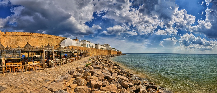 HAMMAMET, TUNISIA - OCT 2014: Cafe on stony beach of ancient Med