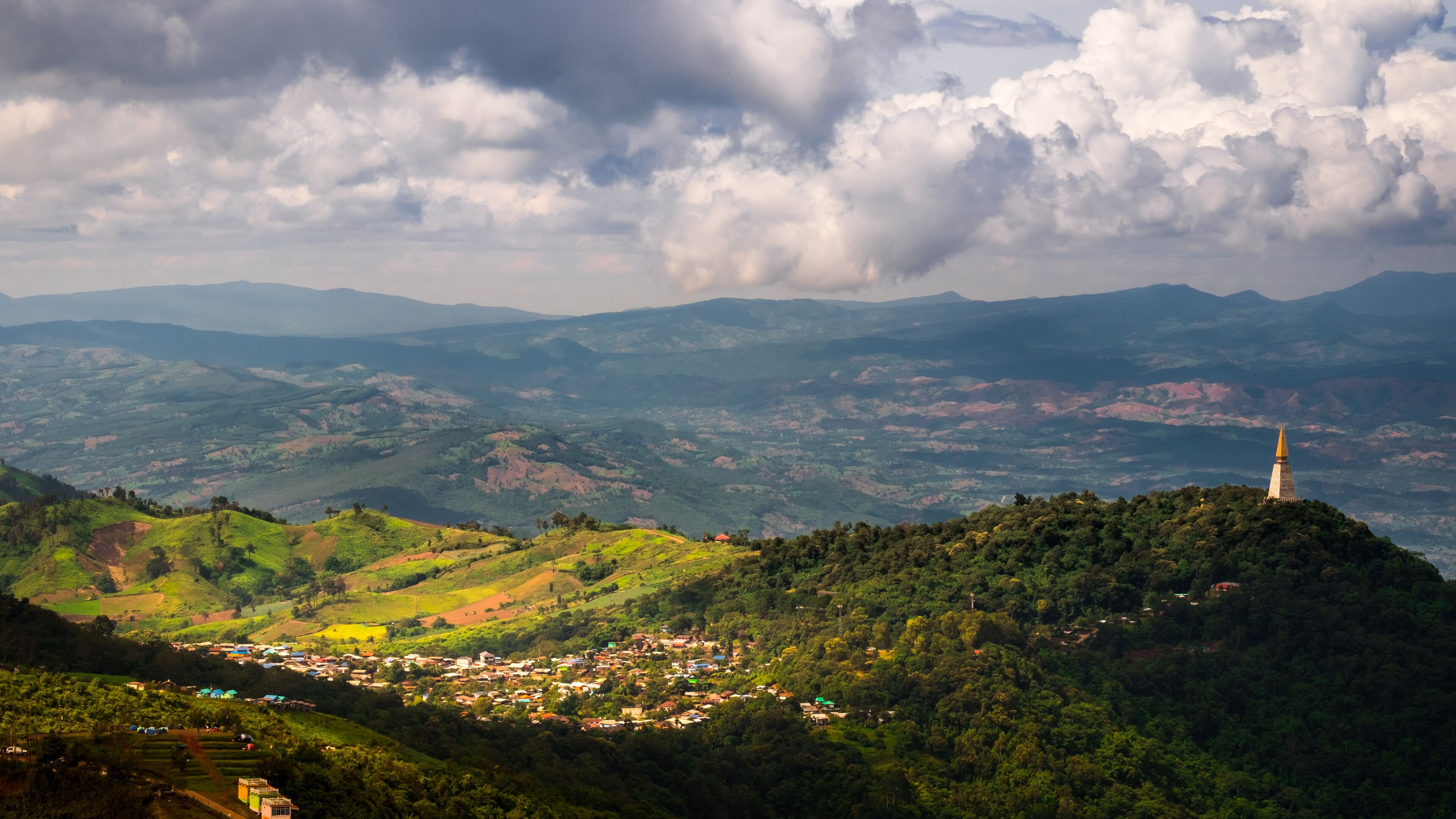 Selective Focus Wat Pa Phu Thap Boek "Buddhist Temple" and Top view Beautiful Scenery Village peaceful On Rock Mountain in Phetchabun Province, Thailand.