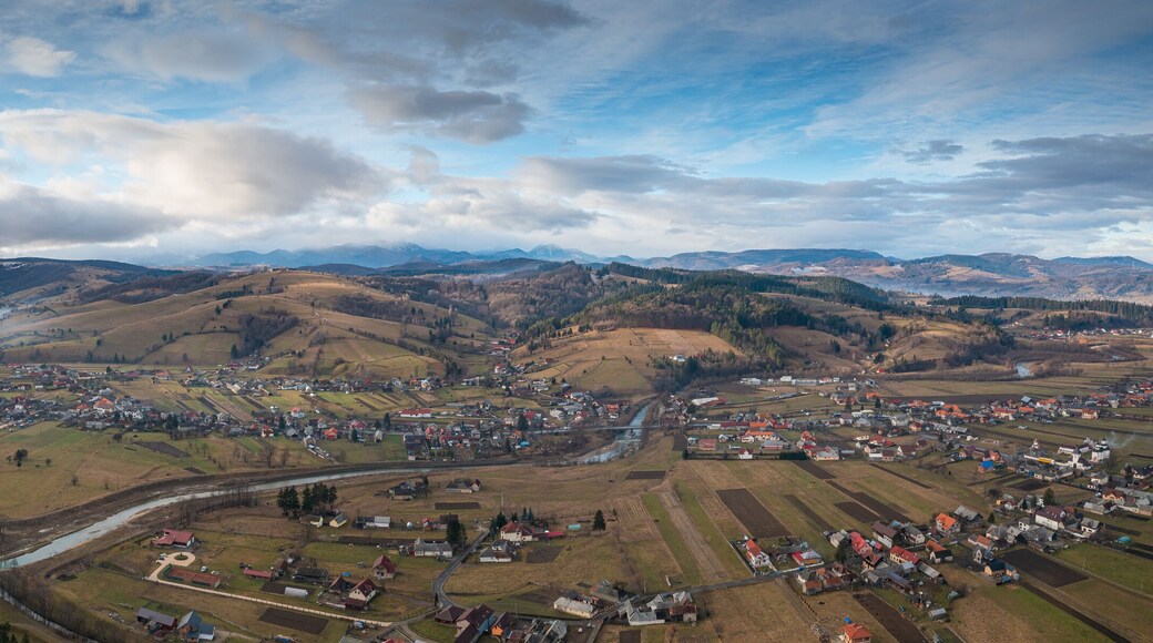 Aerial view over Intorsura Buzaului city from Covasna county in Romania during a cloudy winter day at the bottom of Ciucas Mountains.