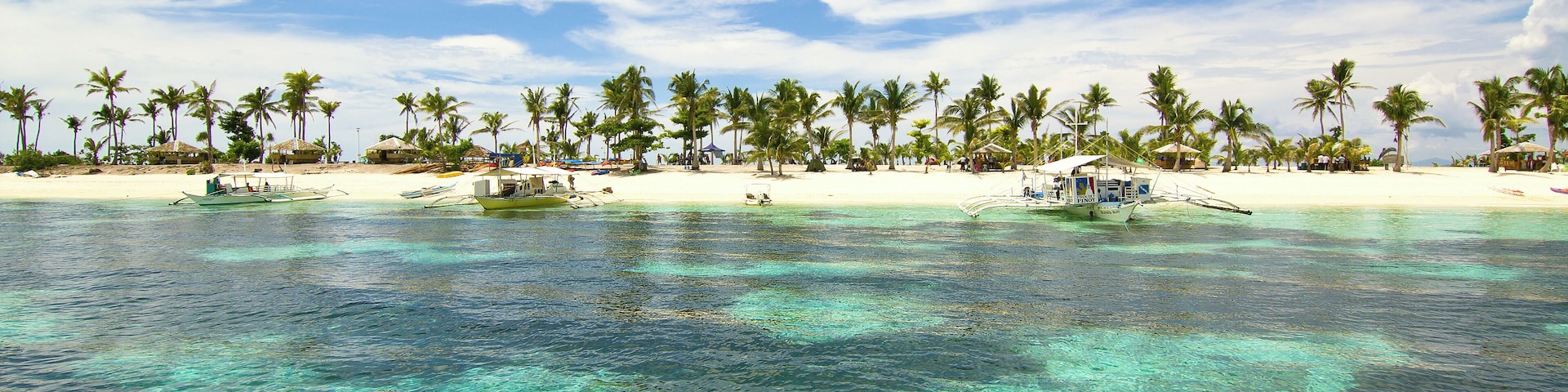 Cerulean skies over turquoise green waters greet us as we approach the pristine beaches of Kalanggaman Island in Palompon, Leyte, Philippines.