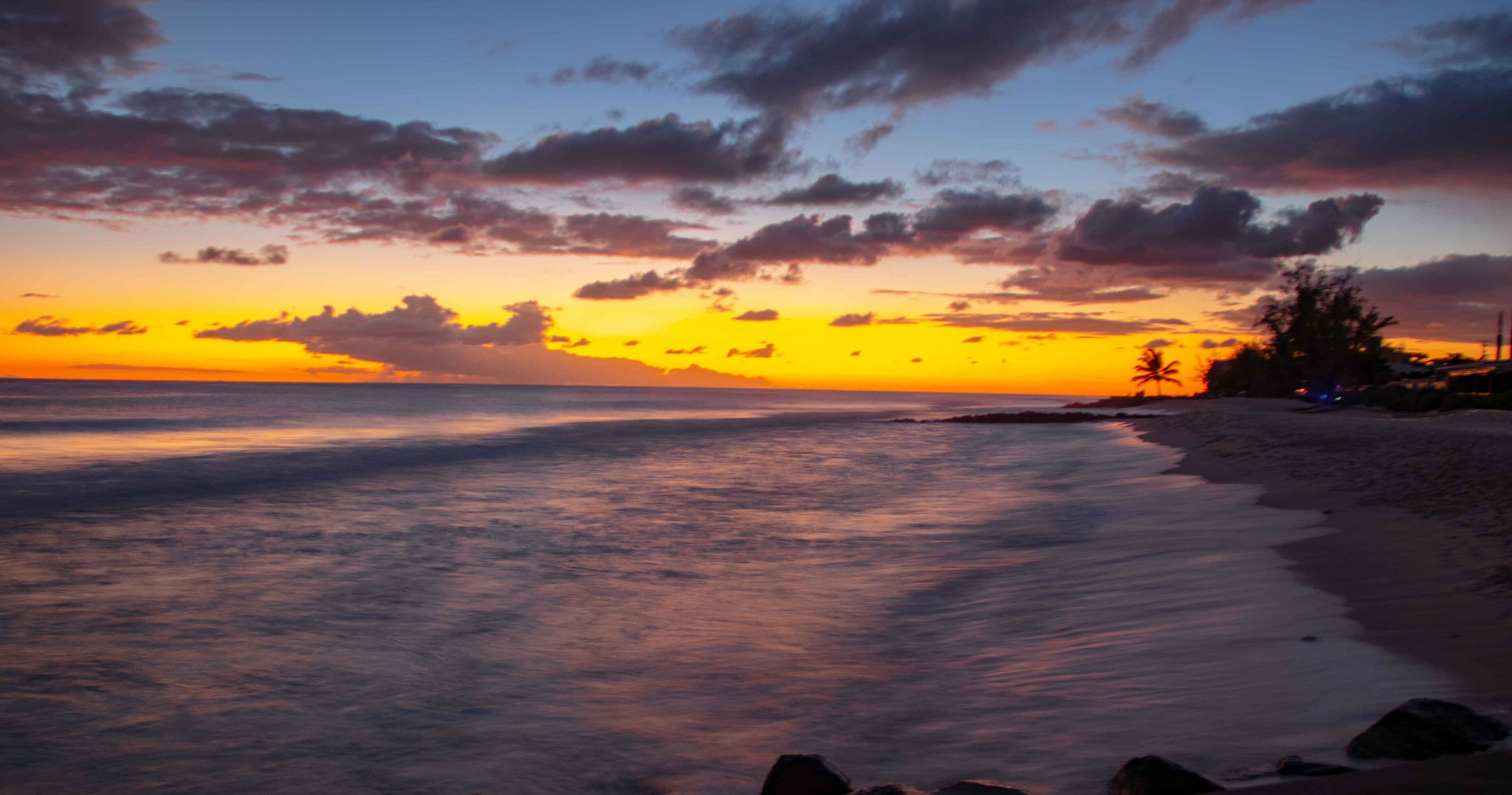 Sunset over smooth waves