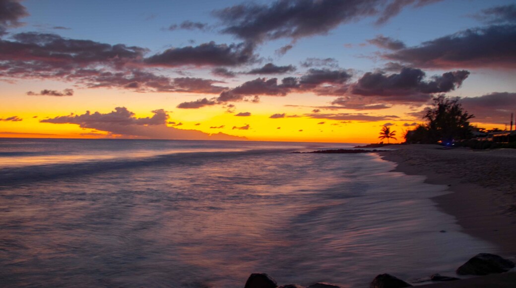 Sunset over smooth waves