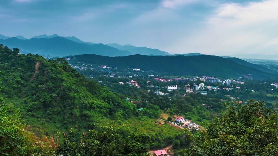 A mountainous landscape with a village nestled among the hills.