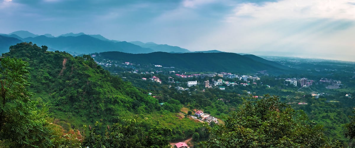 A mountainous landscape with a village nestled among the hills.